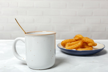 Cup of chocolate sauce with churros