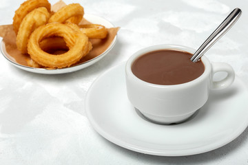 Cup of chocolate sauce with churros