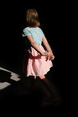girl in beautiful and delicate clothes dancing. dance ballerina in a pink skirt. Game with a shadow. silhouette of a little princess