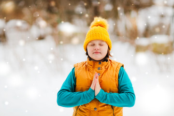 girl kid in yellow hat in asana practices yoga