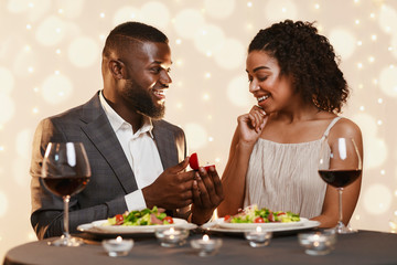 Handsome black man making marriage proposal to his beautiful woman