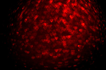 Background with red bokeh in the shape of a heart.