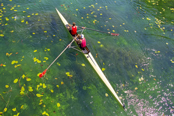 Two young athletes rowing team on green lake © smuki