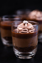 Chocolate mousse in glasses topped with whipped cream