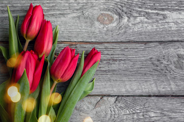 Red tulips on wooden background. Valentine's day concept. 8 march. Mother day concept. Top view.