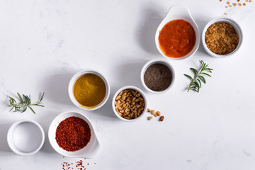 Set of different spices for sauces on stone background.
