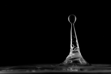 Water splash isolated, water drop hit the surface, water droplet falling and hitting water surface and causing a rebound and explosion