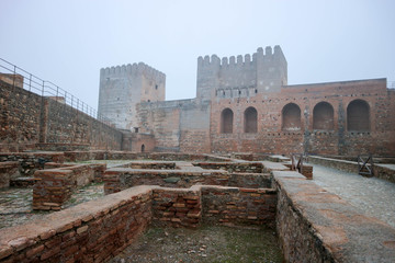 inside view of the medieval citadel alcazaba of alhambra, Granada, Andalucia, Spain in morning fog