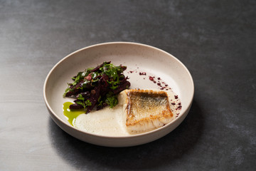 Fried fish perch with vegetables on a white table on grey table