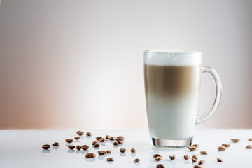 cup of coffee latte and coffee beans on white background