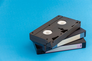 Fototapeta premium Several VHS video cassettes, on a blue background.