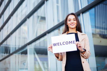 Women business with the poster with welcome message