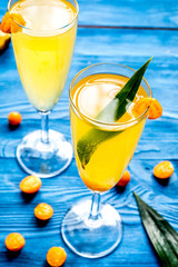 cocktail with physalis in glass on wooden background