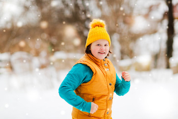kid girl is stretching outside in winter, sport