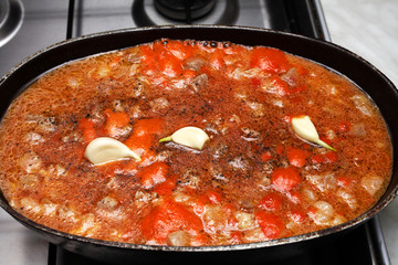 cooking pilaf in stages on a gas stove in a cauldron