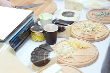 Slicing different varieties of cheese for presentation