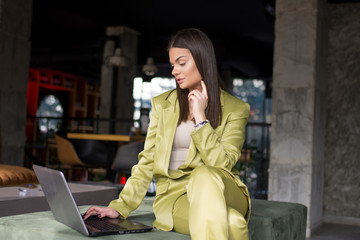 Young blogger working on laptop in a cafe