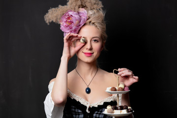 Beautiful blonde countess with chocolate candies - obrazy, fototapety, plakaty