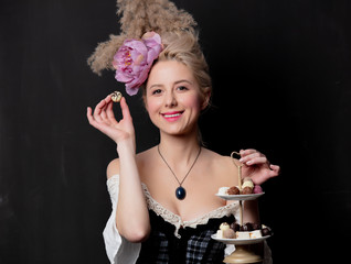 Beautiful blonde countess with chocolate candies