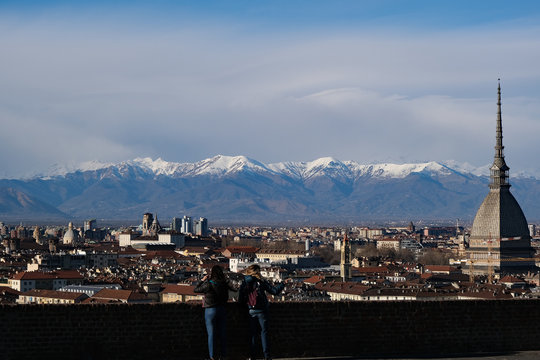 Torino con la Mole Antonelliana e le Alpi innevate sullo sfondo.