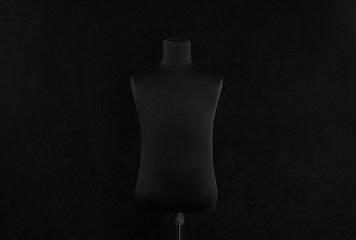 black mannequin isolated on black background