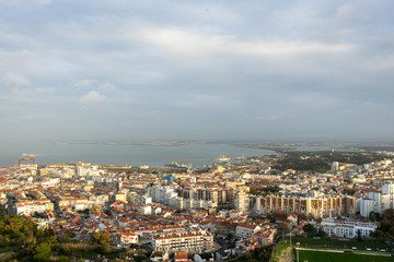 Fototapeta na wymiar City seen from above with gardens and a bay in the background