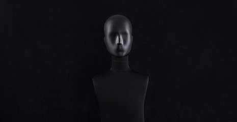 black mannequin head isolated on black background - obrazy, fototapety, plakaty
