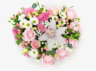 Beautiful valentiens day floral arrangement. Pink roses, white and green flower composition in a heart.