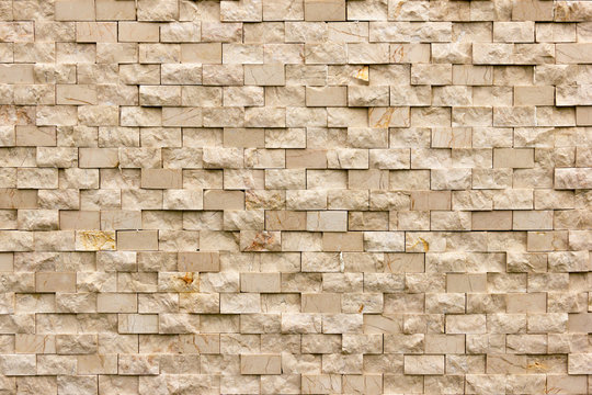 Rectangular marble tiles in beige color. Beige marble wall texture Wallpaper background