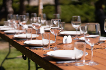 Served wooden table without a tablecloth. Cafe in the open air park