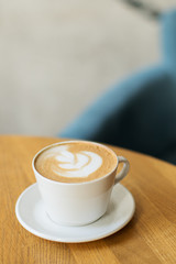 Cup of coffee on wooden table.
