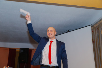Happy groom with a garter of the bride in hand.