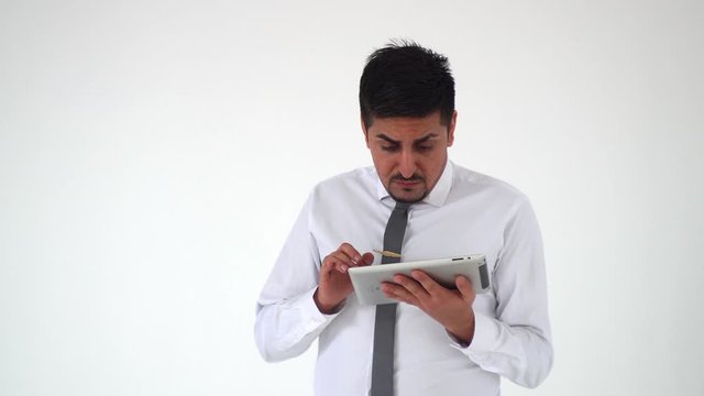 The man checks the tablet and he is very surprised. Shocked worker, shakes his head and does not believe what happened