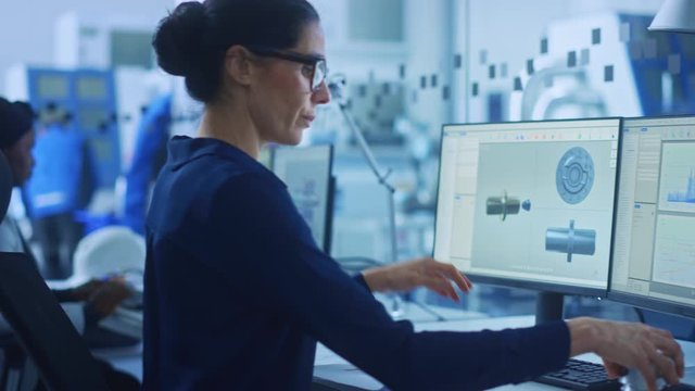 Diverse Team of Industrial Engineers Working in Glass Office, using PC, Doing 3D Modelling in CAD Software