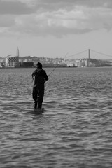 Fisherman fishing in Tagus River