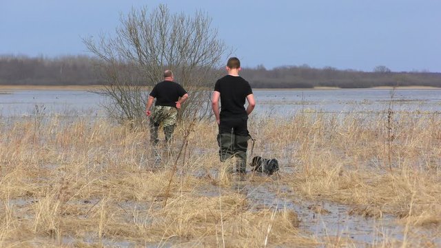 Hunting for migratory wildfowl on the lake Ilmen. Hunters inspect the area before conducting a duck hunt.