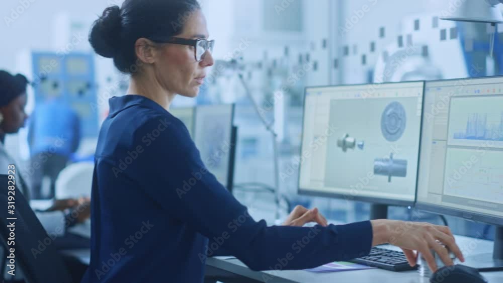 Poster Diverse Team of Industrial Engineers Working in Glass Office, using PC, Doing 3D Modelling in CAD Software. Outside Office Modern Factory Workshop with Professionals Working on CNC Machinery