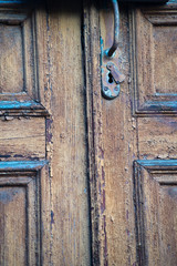 Old natural wooden shabby background close up. Door in old Prague