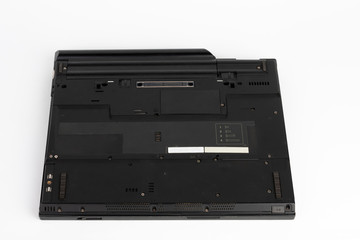 View of the underside of the laptop  on white background, notebook  was produced in 2003.