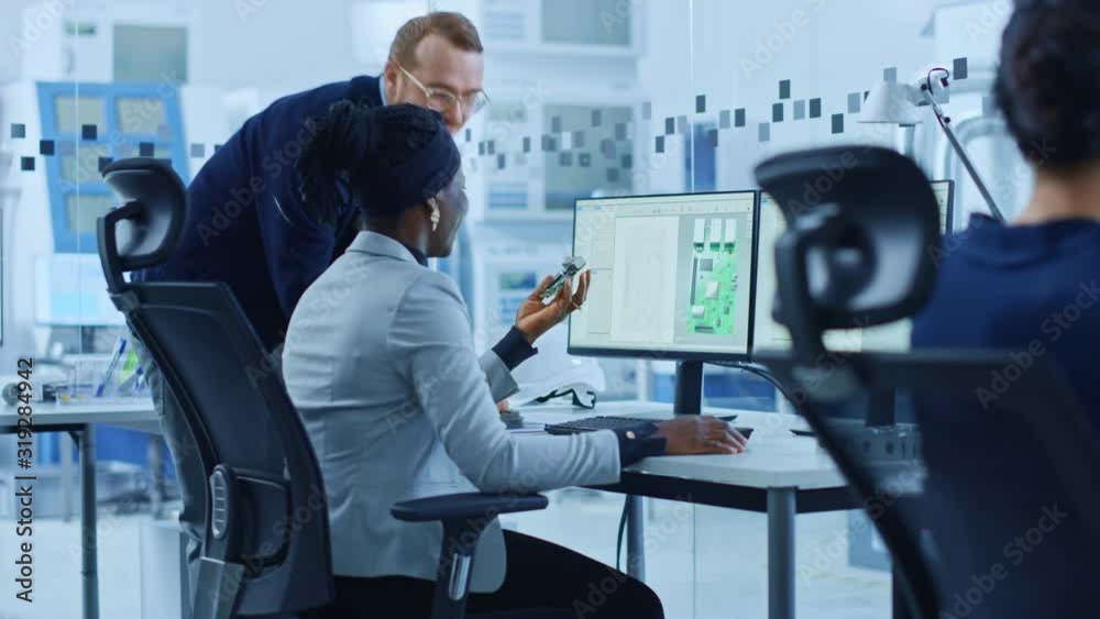Poster modern electronics factory: male manager talks to a female electrical engineer who works on computer