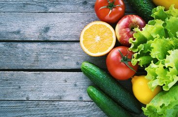 Fresh vegetables and fruits on a wooden background. Space for text. Diet. Fasting. Healthy food.