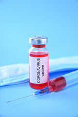 Coronavirus vaccine shot for baby vaccination on blue background, medicine and drug concept