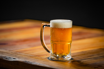 mug full of chopp, with chopp pilsen on a rustic table