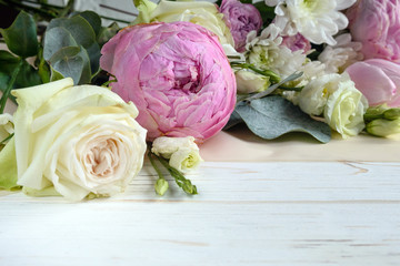 Delicate romantic bouquet for a gift. Huge pink peonies and white roses on a white background. Flower arrangement for Valentine's Day, Mother's Day or International Women's Day.