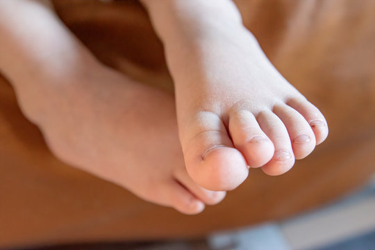 charming kid sings into microphone and opens her mouth wide with milk teeth dropped out.