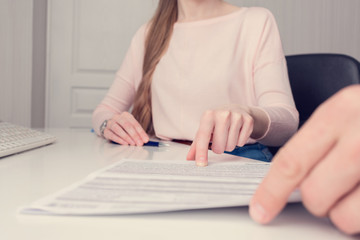 Boss woman indicates an error in the documents, cropped image, close up, toned