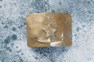 Old brass belt buckle with a star