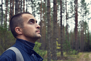 Tourist man in the forest, portrait, toned