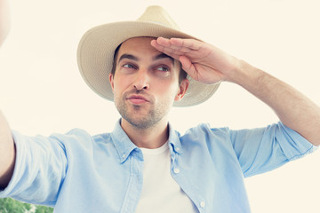 Handsome man communicates on Skype, welcomes his interlocutor, portrait, toned