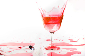 Red alcohol cocktail drink splash on white background .